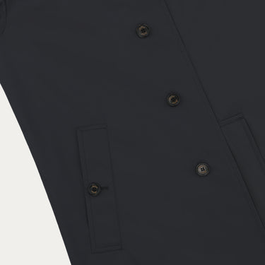 Close-up of Sealup navy raincoat front buttons and pocket detailing, highlighting premium craftsmanship and minimalist design.