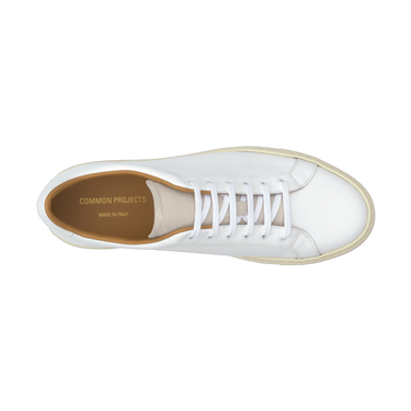 Top view of Common Projects Retro Low white leather sneaker, showcasing clean lacing and gold branding, available at SARTALE.