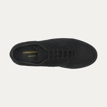 Top view of Common Projects 2487 7547 sneaker in black nubuck leather, showcasing perforated toe and gold branding inside.