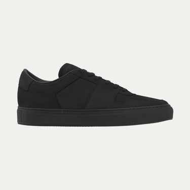 Side profile of black 'Decades' sneaker by Common Projects, featuring sleek nubuck leather and clean panel construction.