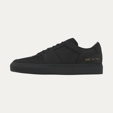Common Projects sneaker in black with signature gold foil code 2487 42 7547 on heel, part of SS25 collection at SARTALE.