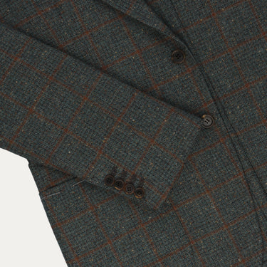 Sleeve detail of Orazio Luciano checked wool jacket featuring four-button cuff and fine tailoring in soft green and brown tones.
