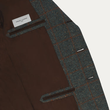Interior view of Orazio Luciano wool checked jacket showing brown lining and inner pockets with brand label, crafted for premium comfort.