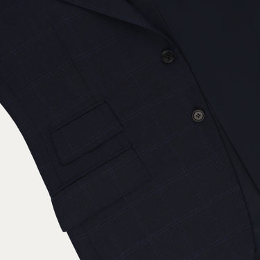 Close-up of Orazio Luciano navy wool suit jacket showing flap pockets and fine check detailing. A premium choice in men’s suits for FW25/26.