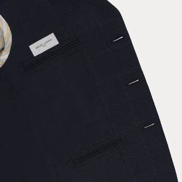 Interior view of Orazio Luciano suit jacket showing label and inner pockets. High-quality tailoring meets luxury design in this navy wool suit.