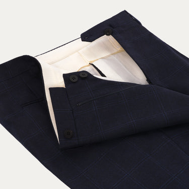 Close-up of waistband and button closure on Orazio Luciano navy wool suit trousers. Designed for comfort and elegance in winter menswear.
