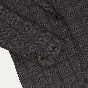 Detail of Orazio Luciano jacket sleeve with four-button cuff and check design, emphasizing tailored elegance and winter style.