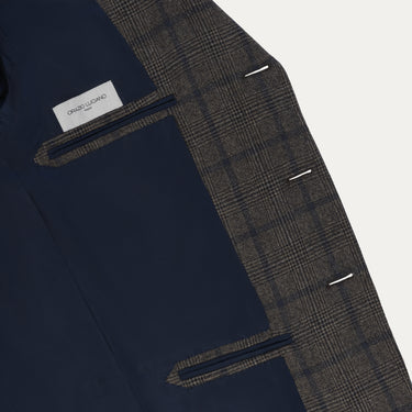 Interior view of Orazio Luciano checked wool jacket with navy lining and label, showcasing luxury tailoring and premium finish.