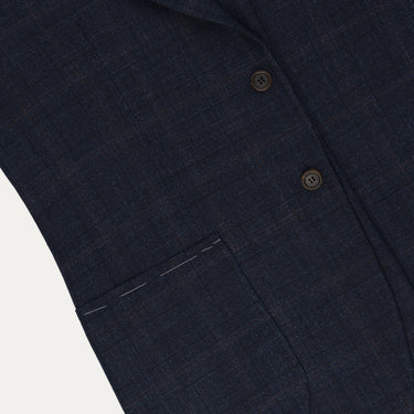 Detailed view of front pocket and fabric texture on Orazio Luciano dark blue and brown checked jacket. Highlights craftsmanship and subtle check pattern.