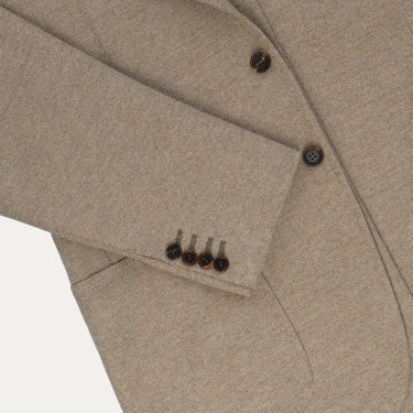 Detail of sleeve buttons and pocket stitching on Orazio Luciano beige wool jacket, emphasizing artisanal construction and style.