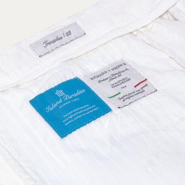 Interior label details of Richard J. Brown Caprera Trousers in White, highlighting Island Paradise fabric and Italian craftsmanship. Shop now at SARTALE.