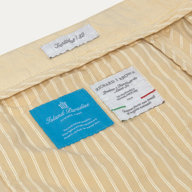 Interior label details of Caprera Cream Trousers by Richard J. Brown, highlighting Island Paradise lining and premium Italian craftsmanship.