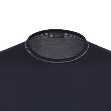 Close-up of Colombo silk T-shirt sweater neckline with contrast stitching and brand label, highlighting premium craftsmanship and minimalist design.
