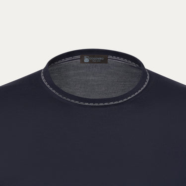 Close-up of Colombo silk T-shirt sweater neckline with contrast stitching and brand label, highlighting premium craftsmanship and minimalist design.