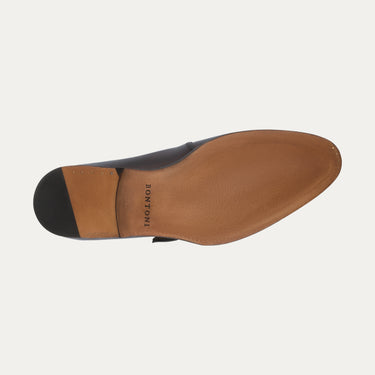 Sole view of Bontoni 'Magnifico Single-Monk' loafer in burgundy, showing smooth leather outsole with Bontoni branding. High-end Italian shoe craftsmanship.