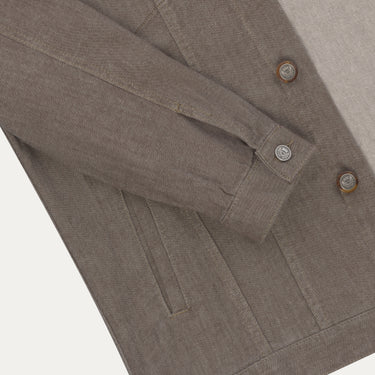 Close-up of sleeve and button detail on Richard J. Brown brown melange denim jacket, highlighting craftsmanship and textured cotton fabric.
