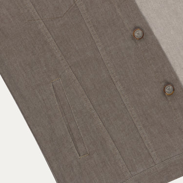 Detailed view of front pocket and button stitching on Richard J. Brown denim cotton jacket in brown melange, emphasizing quality design.