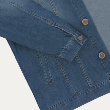 Detailed view of Richard J. Brown denim jacket sleeve and button cuff, emphasizing high-quality cotton-blend fabric and design.