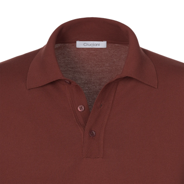 Close-up of Cruciani terracotta cotton polo shirt collar and button placket, highlighting fine craftsmanship and luxury fabric detail.