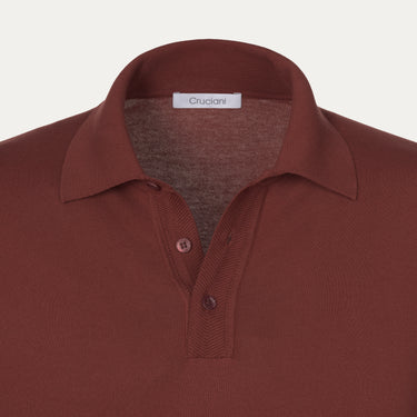 Close-up of Cruciani terracotta cotton polo shirt collar and button placket, highlighting fine craftsmanship and luxury fabric detail.