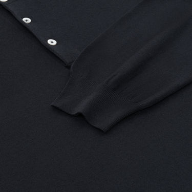 Detail of Cruciani long sleeve polo shirt cuff and hem in dark blue cotton-silk blend, emphasizing luxury knitwear quality and finish.