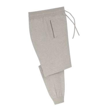 Cruciani knitted cotton trousers in light grey with tapered fit and ribbed cuffs, featured in SARTALE's SS25 trouser collection.