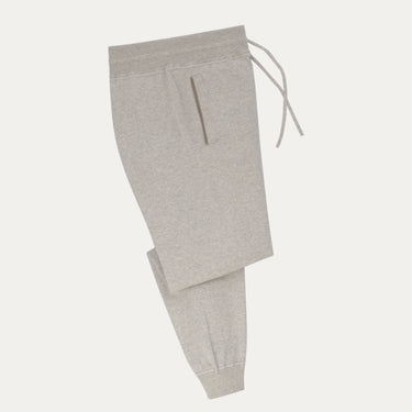 Cruciani knitted cotton trousers in light grey with tapered fit and ribbed cuffs, featured in SARTALE's SS25 trouser collection.