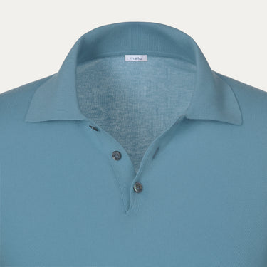 Close-up of Malo polo shirt collar and button placket in light blue cotton, highlighting premium craftsmanship and minimalist design.