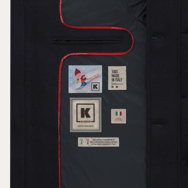 Interior label of Kired Hooded Down Winter Jacket in Blue, featuring 'Made in Italy' and goose down info, part of SARTALE's luxury outerwear.
