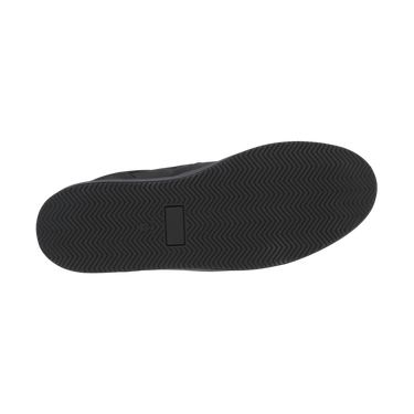 Outsole view of Common Projects 'Decades' black sneaker, showing herringbone tread pattern for grip and durability.