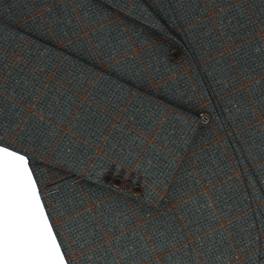 Sleeve detail of Orazio Luciano checked wool jacket featuring four-button cuff and fine tailoring in soft green and brown tones.