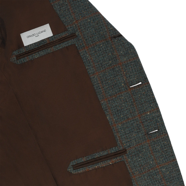 Interior view of Orazio Luciano wool checked jacket showing brown lining and inner pockets with brand label, crafted for premium comfort.