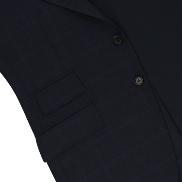 Close-up of Orazio Luciano navy wool suit jacket showing flap pockets and fine check detailing. A premium choice in men’s suits for FW25/26.