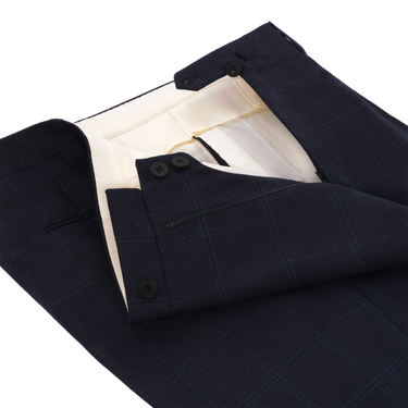 Close-up of waistband and button closure on Orazio Luciano navy wool suit trousers. Designed for comfort and elegance in winter menswear.