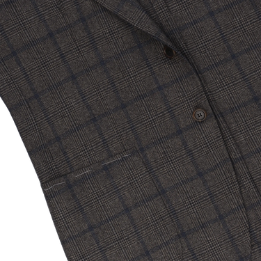 Close-up of Orazio Luciano jacket front pocket and check pattern, highlighting fine wool texture and craftsmanship details.