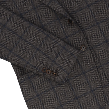 Detail of Orazio Luciano jacket sleeve with four-button cuff and check design, emphasizing tailored elegance and winter style.