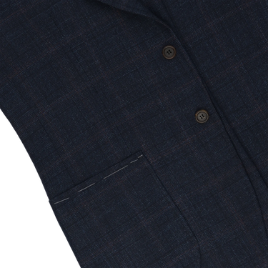 Detailed view of front pocket and fabric texture on Orazio Luciano dark blue and brown checked jacket. Highlights craftsmanship and subtle check pattern.