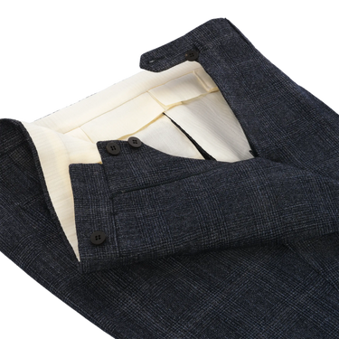 Close-up of waistband and button closure on Orazio Luciano dark blue wool suit trousers, showcasing fine tailoring and premium fabric finish.