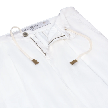 Close-up of Richard J. Brown Caprera Trousers in White, showcasing drawstring waist and zip closure. Premium summer trousers available at SARTALE.