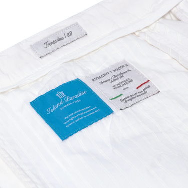 Interior label details of Richard J. Brown Caprera Trousers in White, highlighting Island Paradise fabric and Italian craftsmanship. Shop now at SARTALE.