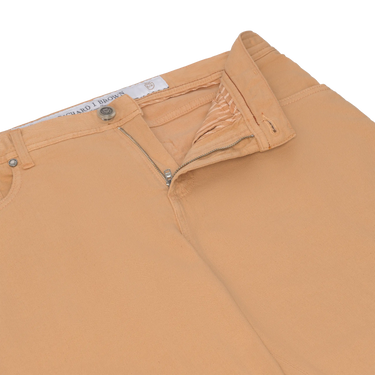 Close-up of Richard J. Brown peach jeans showing zip fly and waistband details, highlighting craftsmanship and premium finish.